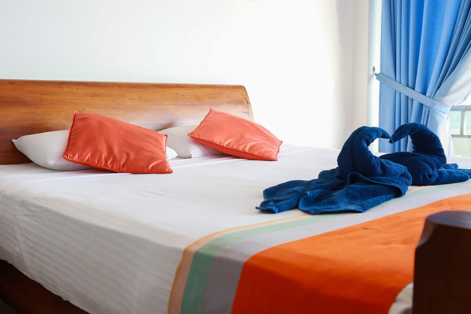 Double bed with bright coastal linens