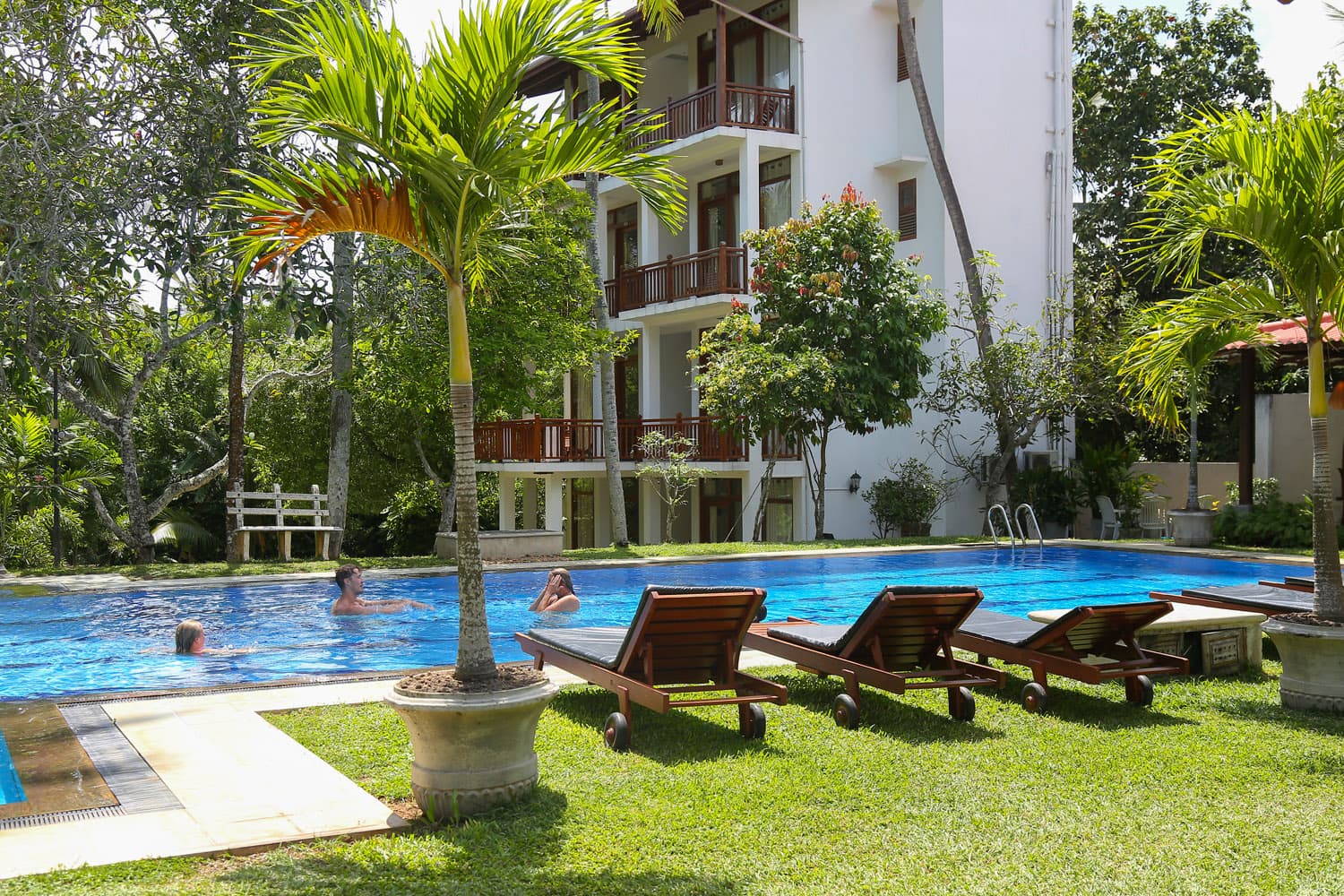 Sun loungers beside the garden pool
