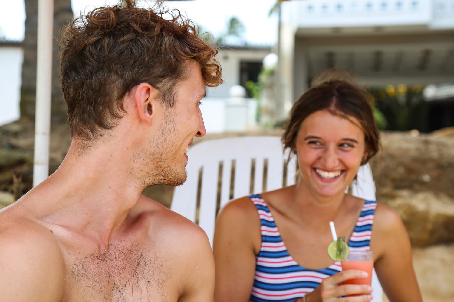 Beachside couple with tropical drinks